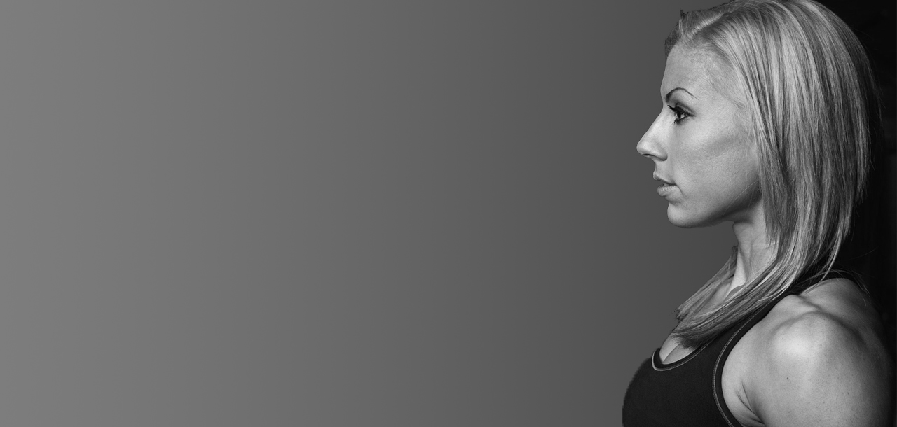 Woman in a black sports bra against a gray background