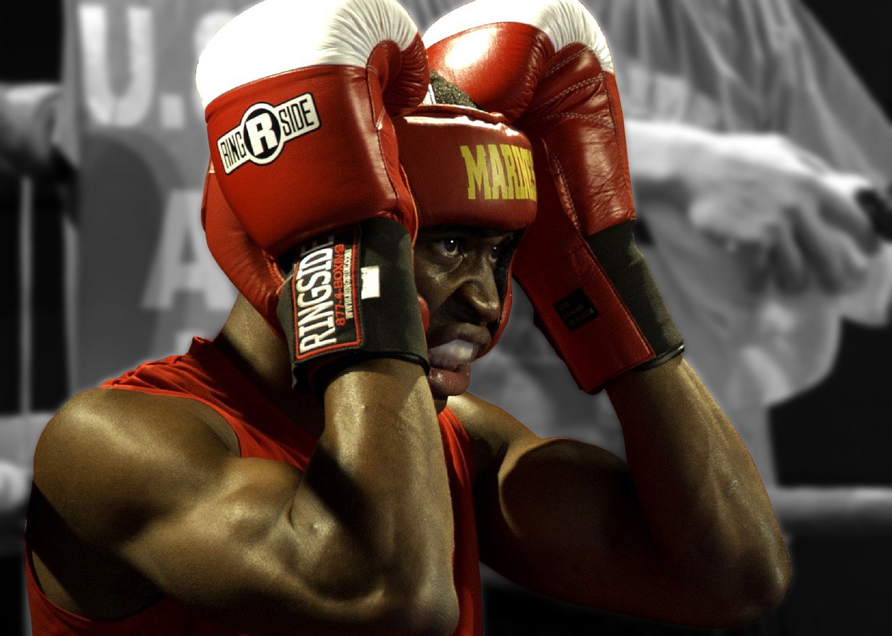 Boxer in red boxing gloves with 'Ringside' branding, wearing a red shirt.